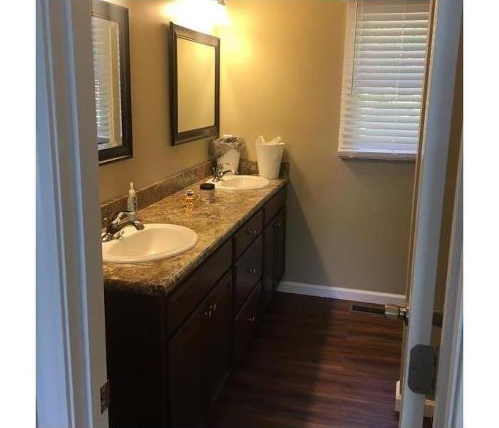 Lit bathroom with twin sinks